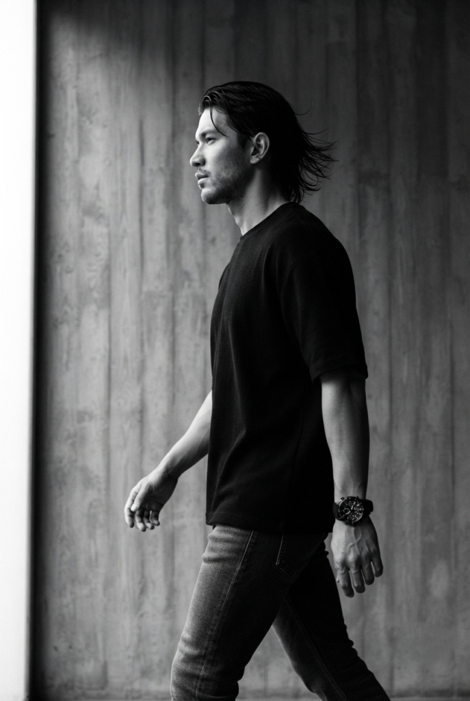 A cinematic black and white portrait of a young man